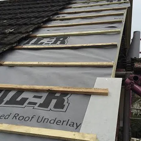 replacing old roof tiles with new ones